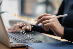 Businessman typing on a computer keyboard, customer service satisfaction survey concept. Business people choose the highest satisfaction rating and give 5 stars. Satisfaction, rating, rating.